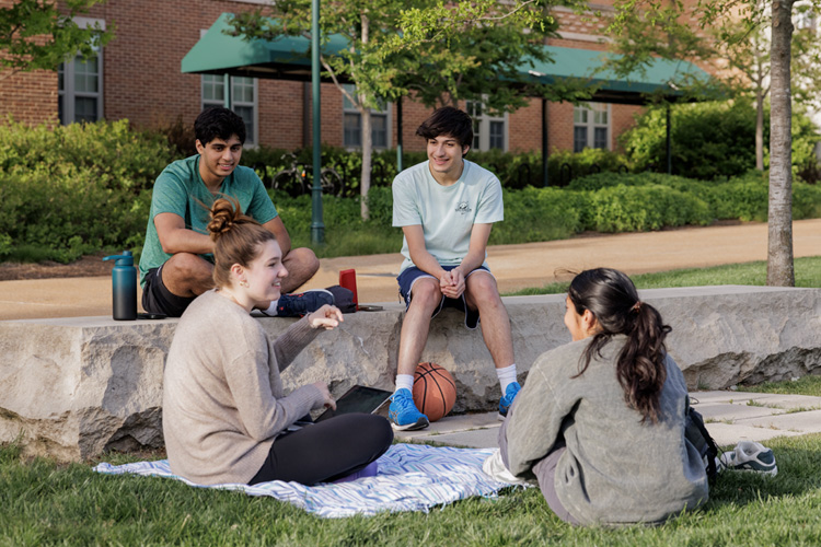 Students sitting outside chatting