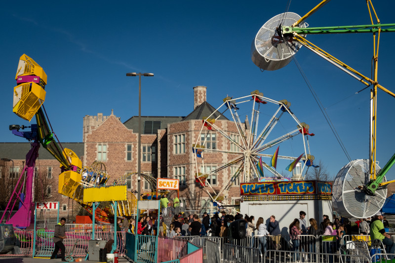 view of crowd in front of carnival rides at the WashU Thurtene Carnival