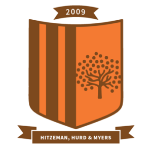 an orange crest with three verticle brown stripes on the left side and a brown tree on the right side
