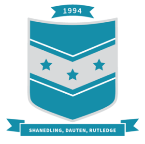 a teal crest with a silver chevron pattern and 3 teal stars in the middle