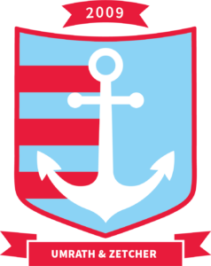 a crest with a blue background, three red stripes on the left side that go halfway through the crest and connect with a large white anchor in the middle of the crest